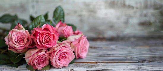 Wall Mural - Pink roses bouquet on wooden backdrop with copy space image.