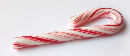 Aufkleber - Close-up view of a Christmas candy cane with peppermint stripes on a white background, perfect for a copy space image.