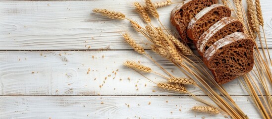 Poster - Health and diet concept showcased with rye bread slices and wheat ears on a light wooden background, perfect for copy space image.