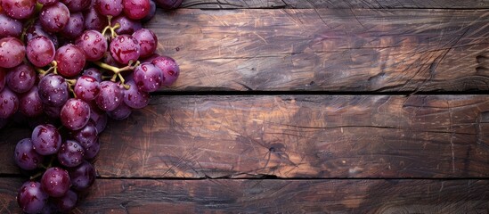 Poster - Close-up of grapes on a wooden background with copy space image.