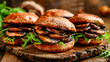 © milicenta - Burgers with eggplant and arugula on wooden cutting board.