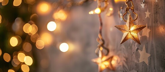 Aufkleber - A garland of stars adorns a gray wall, creating a festive atmosphere perfect for New Year and Christmas celebrations with a blurred background behind, ideal for a copy space image.