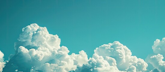 Poster - Fluffy clouds drift peacefully in a clear blue sky, offering a serene copy space image.
