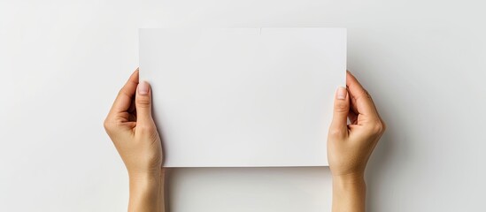 Poster - Hands clasping an empty paper with room for text, on a white background for a copy space image.