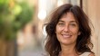 © gn8 - Smiling Middle Aged Italian Woman with Shoulder Length Hair Outdoors, Street Background Ideal for Lifestyle and Travel Content