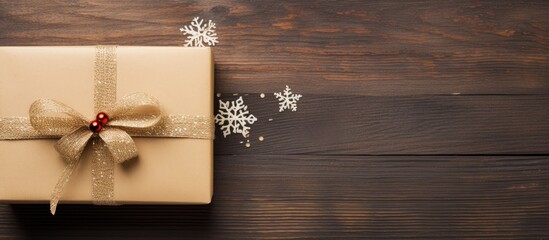 Aufkleber - Top view of a handcrafted Christmas gift box in kraft paper on a wooden surface, with ample copy space for text, accompanied by a greeting card.