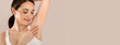 © Prostock-studio - Armpit Depilation Concept. Happy Young Lady Looking At Her Smooth Underarms, Smiling Woman Wearing Underwear Standing With Hands Up Over Beige Studio Background, Copy Space