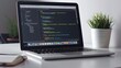 © fivan - A laptop screen displaying software or a website design, with a stylish desk setup including a plant and coffee cup
