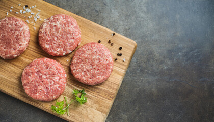 Wall Mural - Raw veal cutlets on chopping board, before cooking for hamburgers and other dishes. Tasty food.