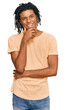 © Krakenimages.com - Young african american man wearing casual clothes looking confident at the camera smiling with crossed arms and hand raised on chin. thinking positive.