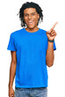 © Krakenimages.com - Young african american man wearing casual clothes showing and pointing up with finger number one while smiling confident and happy.