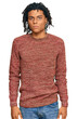 © Krakenimages.com - Young african american man wearing casual winter sweater with serious expression on face. simple and natural looking at the camera.
