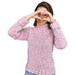 © Krakenimages.com - Young caucasian girl wearing wool winter sweater doing heart shape with hand and fingers smiling looking through sign