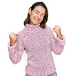 © Krakenimages.com - Young caucasian girl wearing wool winter sweater very happy and excited doing winner gesture with arms raised, smiling and screaming for success. celebration concept.