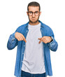 © Krakenimages.com - Young caucasian man wearing casual clothes pointing down looking sad and upset, indicating direction with fingers, unhappy and depressed.