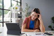 ©  NCST Studio - Businesswoman is experiencing stress and headache while working on a laptop computer, highlighting the pressures of a demanding job