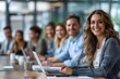 © IL - Free-spirited office workers sitting at a desk in an open office, smiling and having a free meeting with conference materials such as special books and data materials.