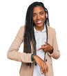 © Krakenimages.com - African american woman wearing business jacket in hurry pointing to watch time, impatience, upset and angry for deadline delay