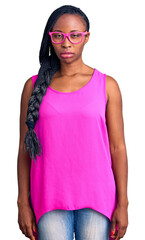 Wall Mural - Young african american woman wearing casual clothes and glasses skeptic and nervous, frowning upset because of problem. negative person.