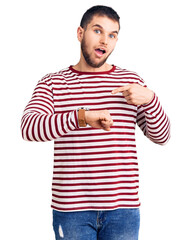 Sticker - Young handsome man wearing striped sweater in hurry pointing to watch time, impatience, upset and angry for deadline delay