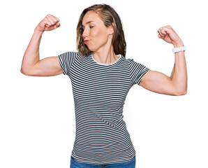 Poster - Young blonde woman wearing casual clothes showing arms muscles smiling proud. fitness concept.