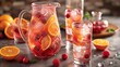 © Emiliia - A pitcher and two glasses filled with a refreshing drink made with citrus fruits and raspberries, surrounded by orange slices and raspberries on a countertop.