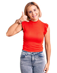 Canvas Print - Young blonde woman wearing casual clothes smiling doing phone gesture with hand and fingers like talking on the telephone. communicating concepts.