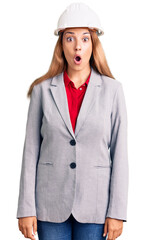 Canvas Print - Beautiful young woman wearing architect hardhat afraid and shocked with surprise expression, fear and excited face.