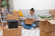 © olga_demina - Attractive brunette female opens large packaging boxes in new apartment examining integrity of various transported furnishings to new home in another town