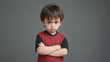 © Christoph Burgstedt - A very upset and agitated child crosses his arms and is in a bad mood and angry at something and shows a grim facial expression or shouts loudly