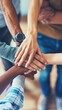 © Nicolai - business people with their hands together showing unity and support in a team meeting