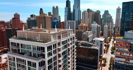 Wall Mural - Rising along the beautiful high-rise building with open balconies. Revealing view on Chicago downtown with stunning skyscrapers on sunny day.