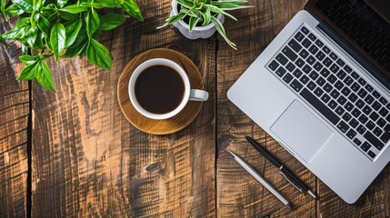 Wall Mural - Work from home concept Office desk setup with a laptop blank notepad coffee cup and pen on a wooden table Top view with copy space in a flat lay style
