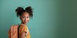 © Irene - Horizontal photography of smiling mixed-race girl with a school backpack on her back, isolated over blue background, back to school concept