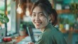 © PixelAI - A young Asian woman in casual green attire smiles as she works on her small business online, reflecting happiness and entrepreneurial spirit