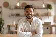 © Skyfe - Smiling Caucasian Young Man in White Shirt with Arms Crossed - Professional Portrait for Business Websites