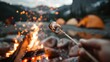 © svastix - A delightful image of a toasted marshmallow on a stick over a crackling campfire, set against the backdrop of two orange tents under a twilight sky, representing joy and camaraderie.
