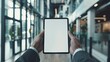 © chanidapa - Businessman presenting digital tablet mockup with blank screen in contemporary office environment. Customizable design display.