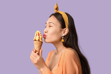 Poster - Beautiful Asian woman with mango ice-cream on lilac background