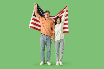 Canvas Print - Young couple with flag of USA on green background