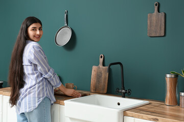 Pretty young woman in modern kitchen