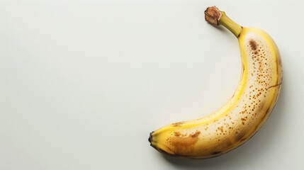 Wall Mural - Ripe banana against white backdrop with space for text