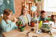© Pixel-Shot - Female teacher with recycle sign and pupils planting during Ecology lesson in classroom