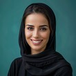 © Lem - Portrait of a beautiful woman in a black headscarf smiling against a teal background.