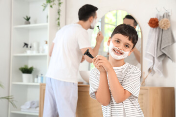 Poster - Father and his happy little son holding razors with shaving foam in bathroom