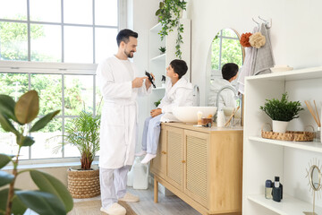 Sticker - Happy father and his little son with trimmer shaving in bathroom