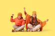 © Pixel-Shot - Cute little happy children in winter clothes on yellow background