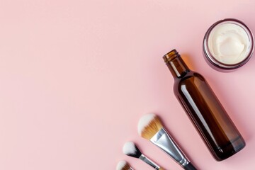 Wall Mural - An amber glass bottle, makeup brushes, and a jar of cream are arranged on a pink background, copy space