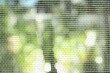 © New Africa - Insect screen for window against blurred background, closeup