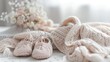 © The 2R Artificiality - Knitted baby shoes and clothes with copy space on white background vertical photo for celebrating a baby girl s birth Concept of pregnancy and motherhood